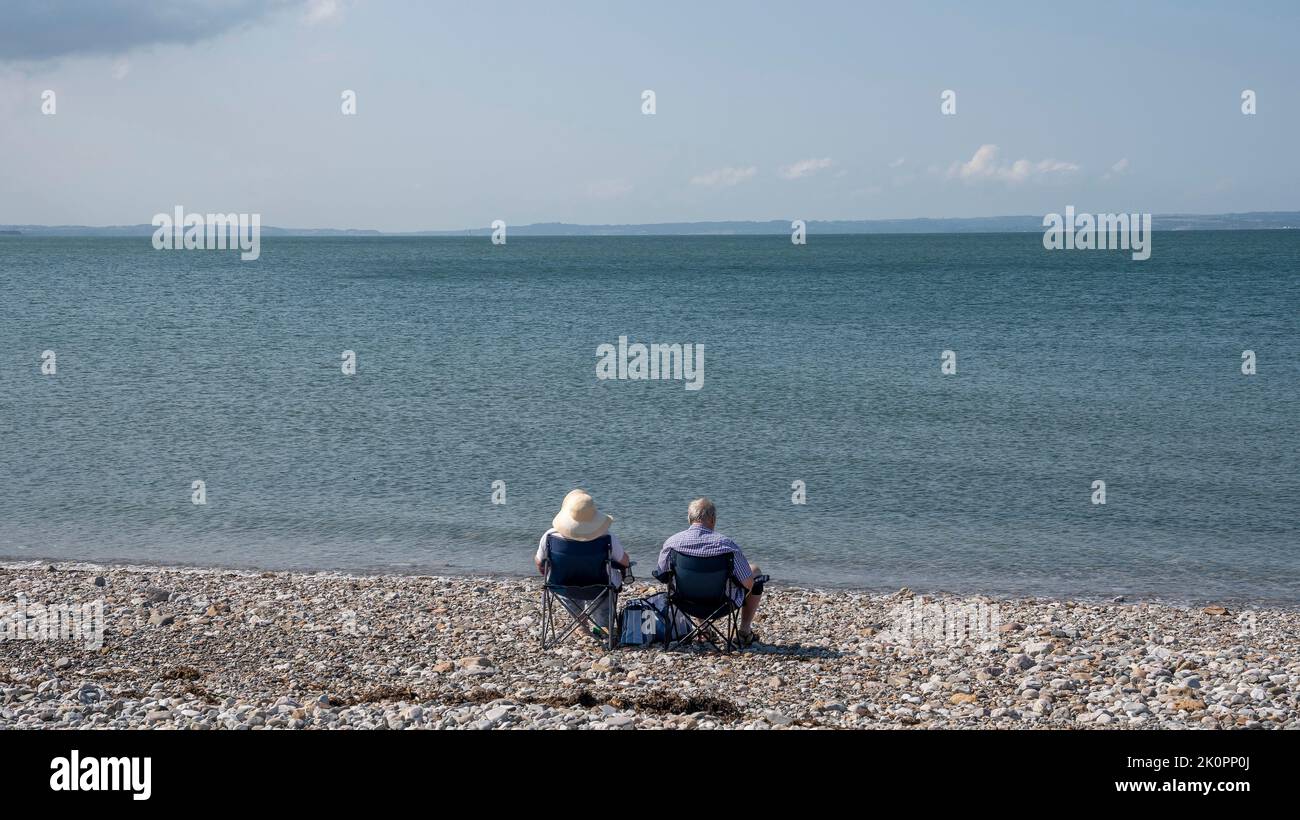 Wish You Were Here holidaymakers on West Shore beach at Llandudno on the coast of North Wales, UK. Stock Photo