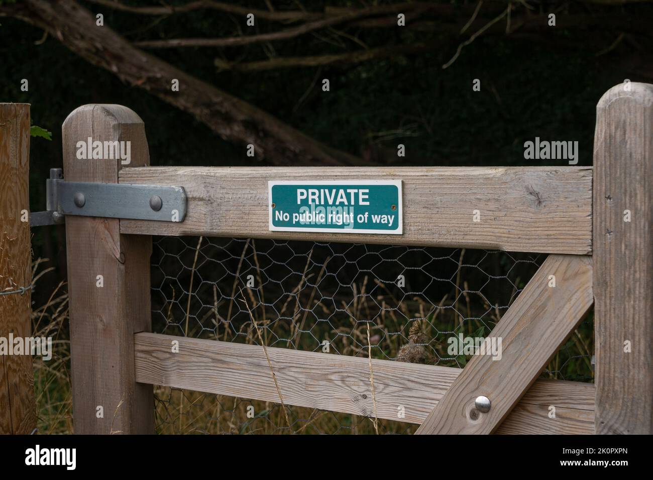 Private, no right of way sign on a wooden gate in the countryside. Stock Photo