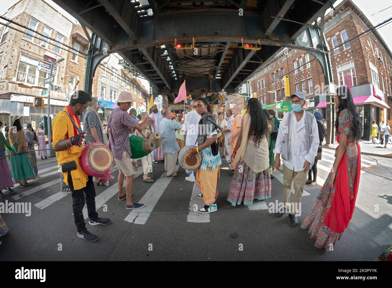 A fisheye lens view of marchers & musicians at the Hindu Ratha Yatra parade on LIberty Ave in Richmond Hill, Queens, New York City. Stock Photo