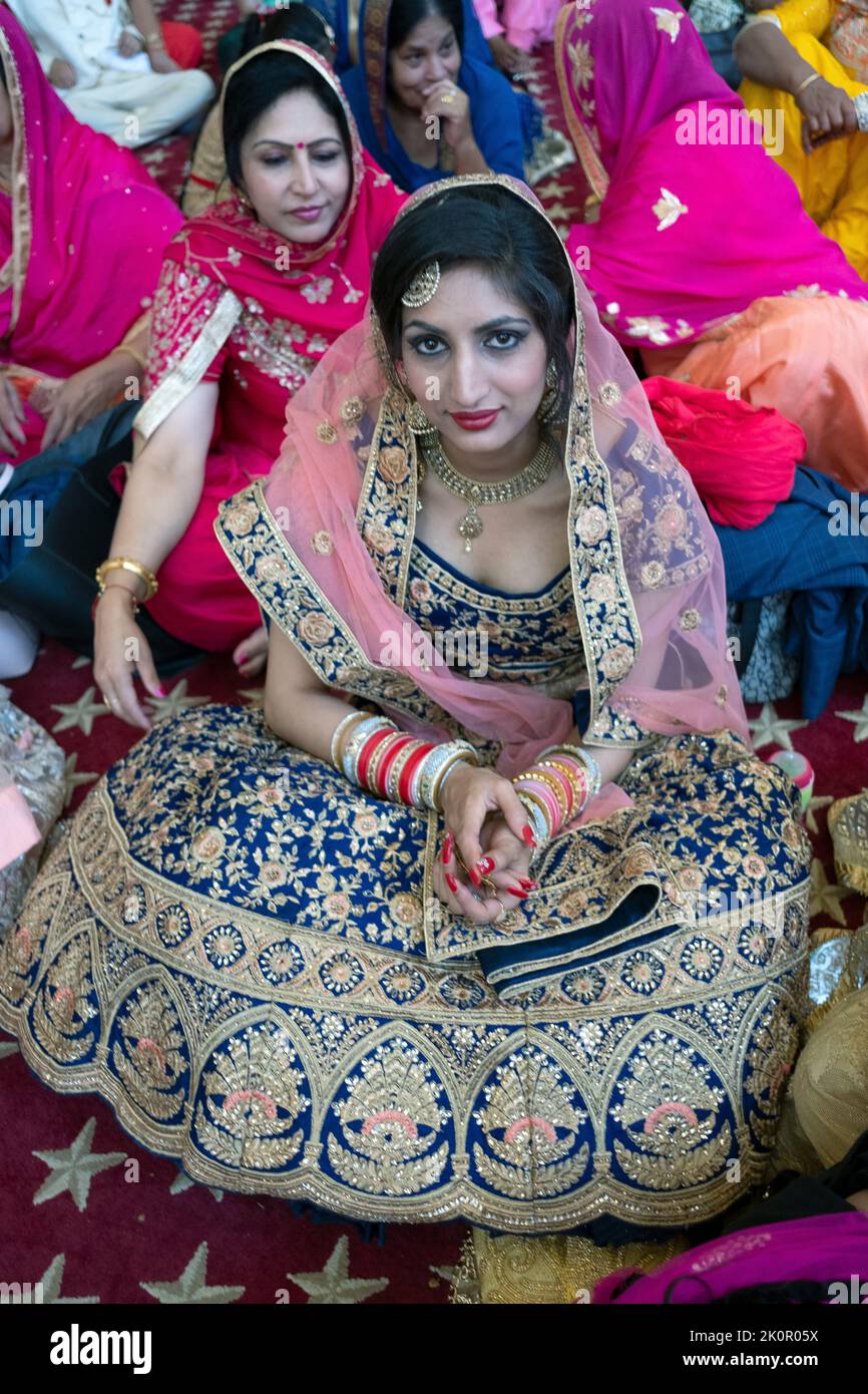 A beautiful guest at a Sikh wedding seated in the women's section. At