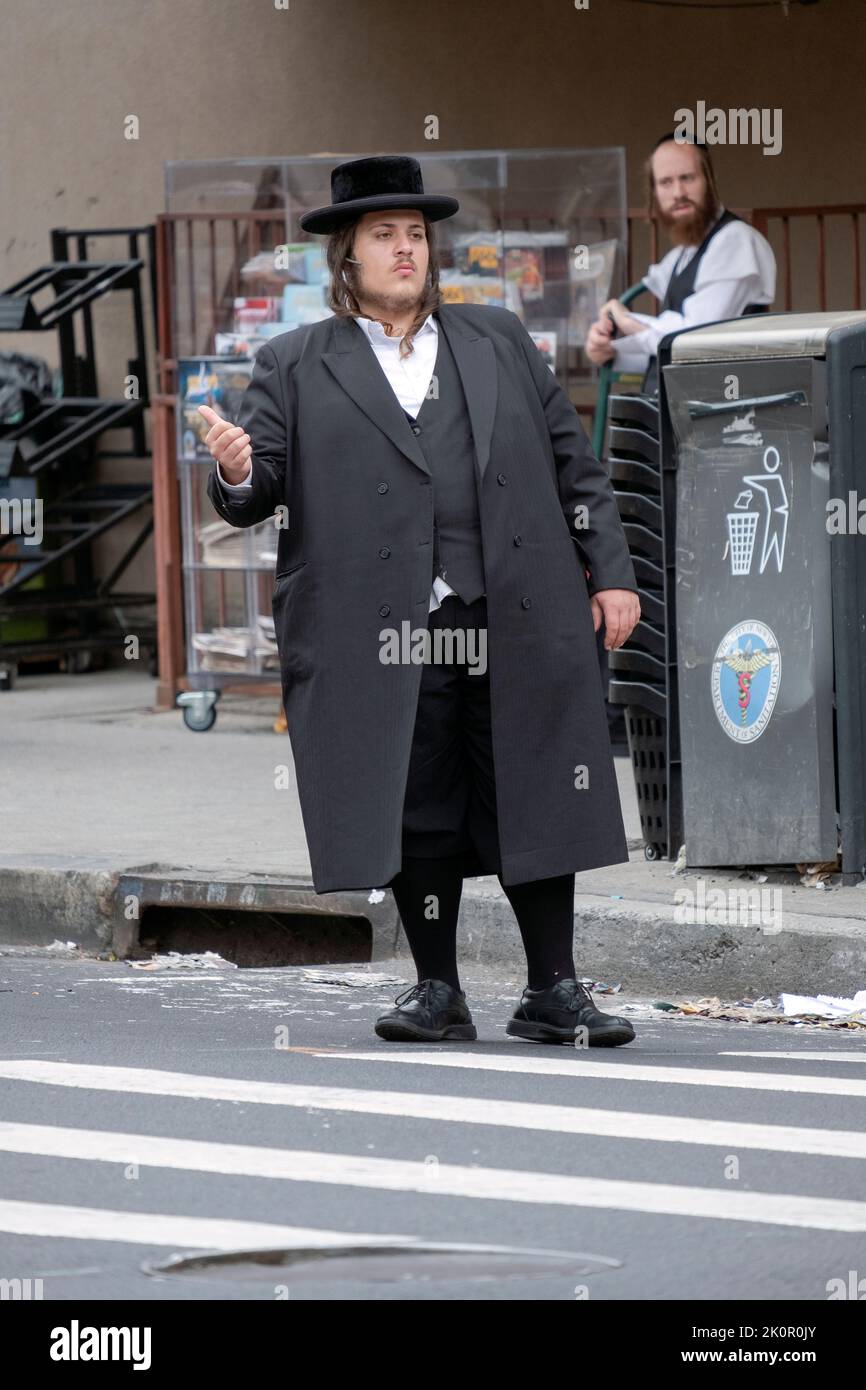 An orthodox Jewish man in Williamsburg hitching a ride, likely from a member of his community, to another NYC Jewish neighborhood. Stock Photo