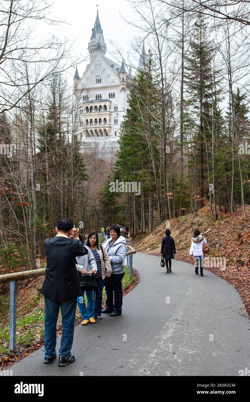 Hohenschwangau, Germany - April 28, 2013: Tourists from China taking photo by Neuschwanstein Castle in the Bavarian Alps Stock Photo