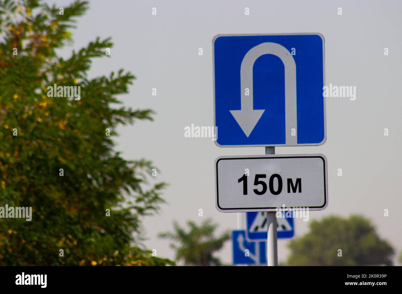 traffic direction sign white reverse arrow on blue background Stock Photo