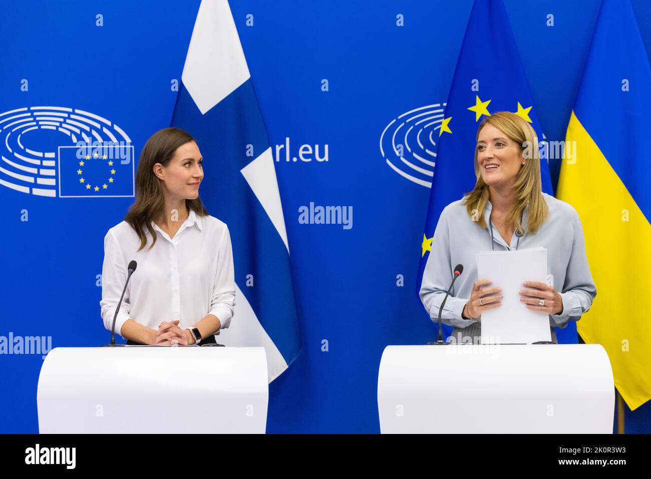 13 September 2022, France, Straßburg: Sanna Marin (SDP, l), Prime Minister of Finland, stands next to Roberta Metsola (Partit Nazzjonalista, r), President of the European Parliament, in the European Parliament building and listens to her. MEPs are discussing uniform rules for minimum wages in the EU on Tuesday. In addition, several votes, for example on the protection of forests in third countries, are on the agenda. Photo: Philipp von Ditfurth/dpa Stock Photo