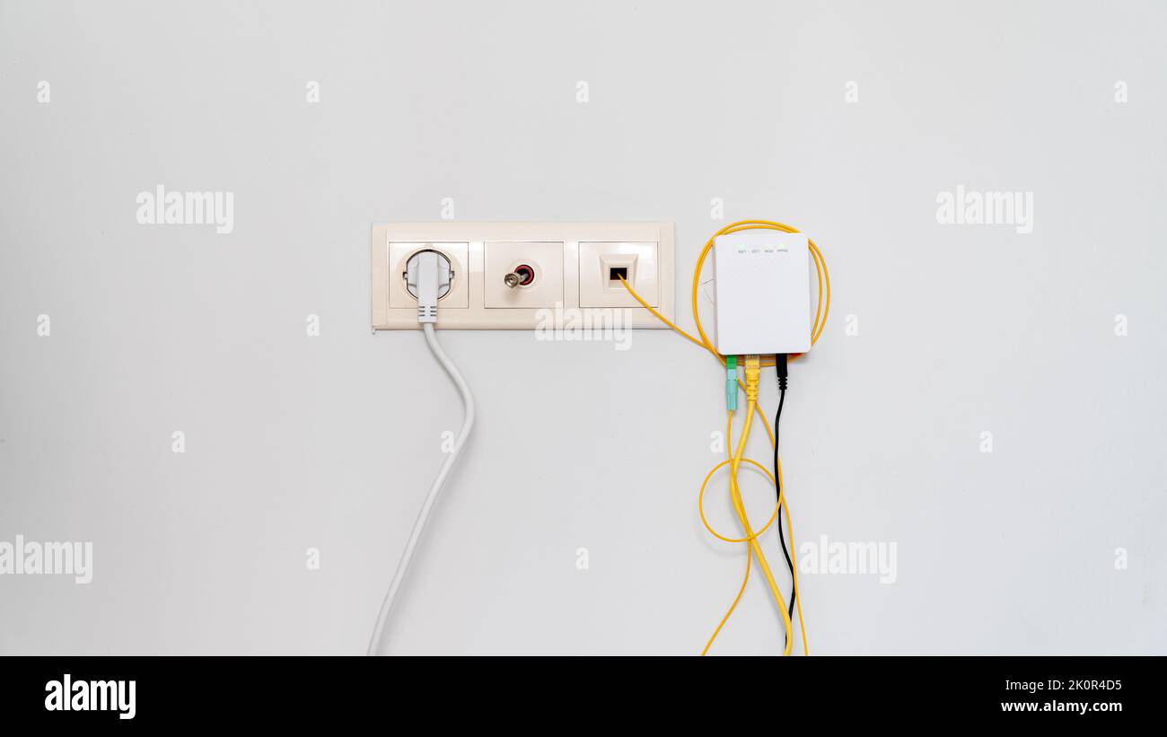 Socket with tangled wires, cables and Internet router on a white background Stock Photo