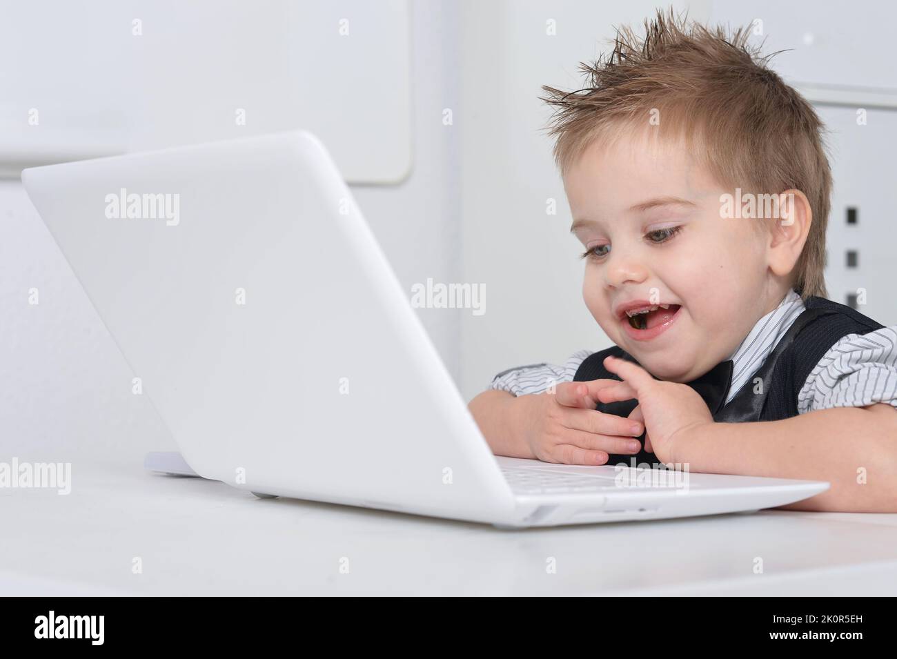 Computer Hand Boy Little handsome boy sits with a computer Stock Photo - Alamy