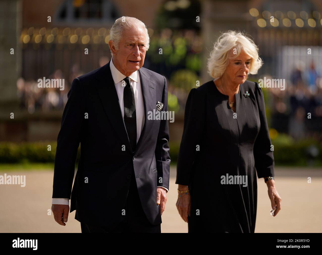 King Charles III and the Queen Consort view floral tributes left outside Hillsborough Castle, Co Down, following the death Queen Elizabeth II on Thursday. Picture date: Tuesday September 13, 2022. Stock Photo