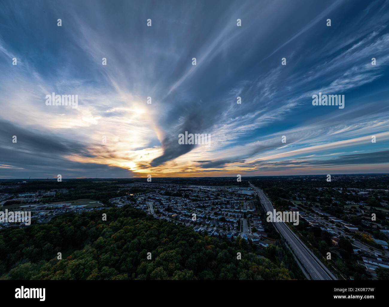 An aerial view of breathtaking orange and blue cloudy sunset over