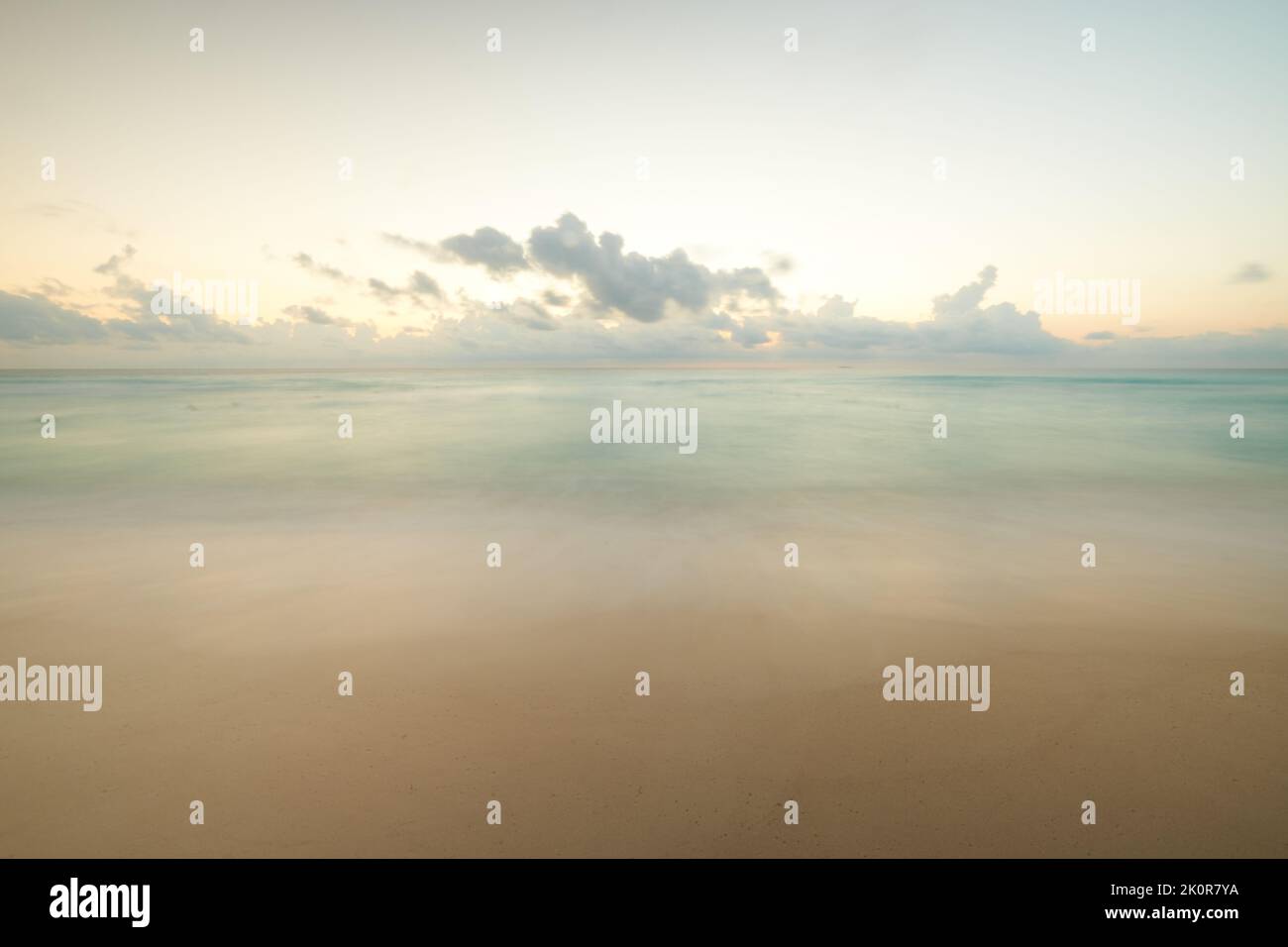 A pastel sunset sky over a beautiful seashore Stock Photo - Alamy
