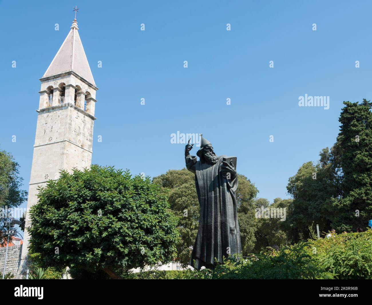 Statue of Bishop Gregory of Nin by sculptor Ivan Mestrovic and bell tower of the Chapel of the Holy Arnir in Split, Croatia, Europe. Stock Photo