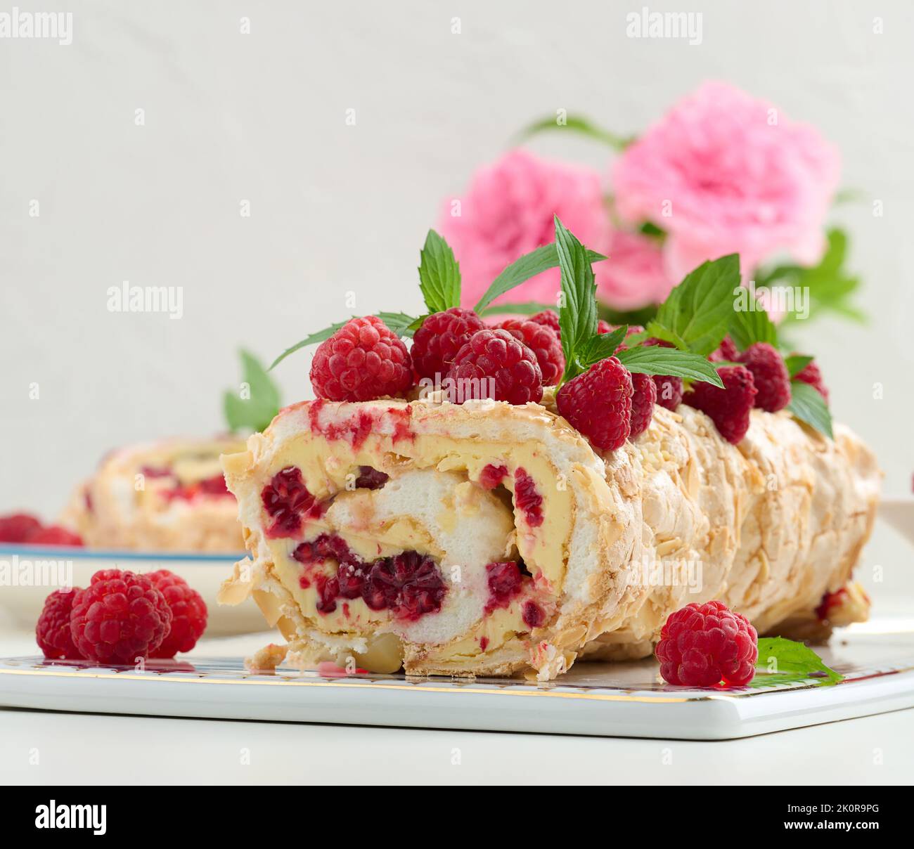 Baked meringue roll with cream and fresh red raspberry, white ...