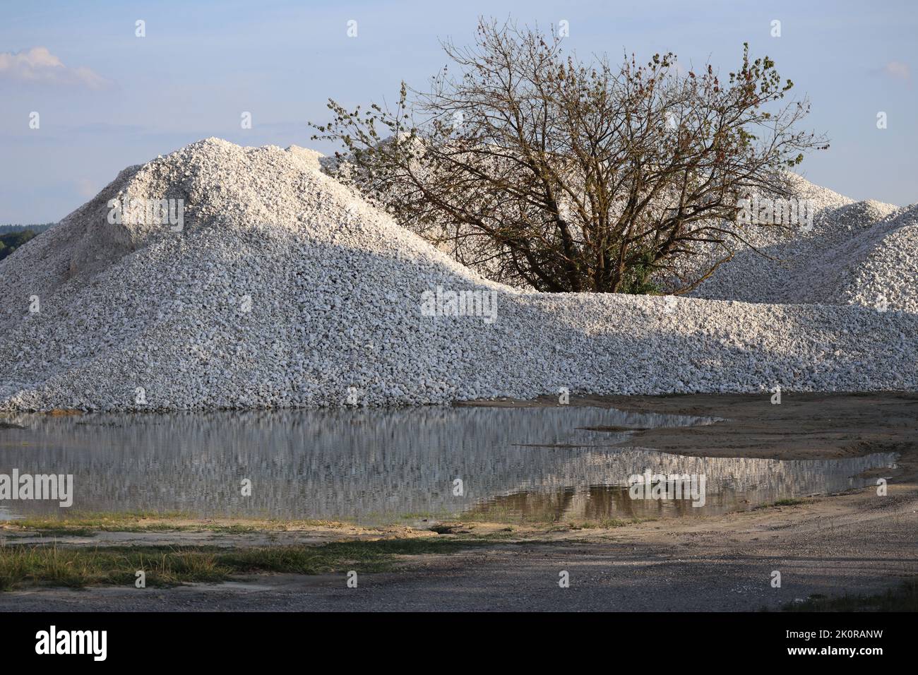 a Heap of Gypsum is reflected in a Puddle Stock Photo