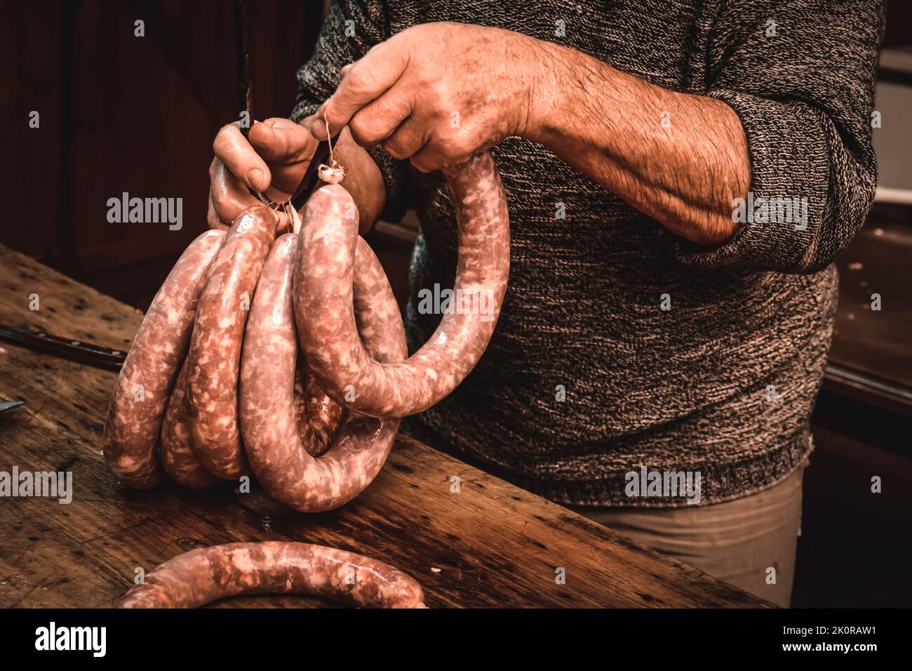 Hands working on the elaboration of sausages, traditional Argentine slaughtering. Stock Photo