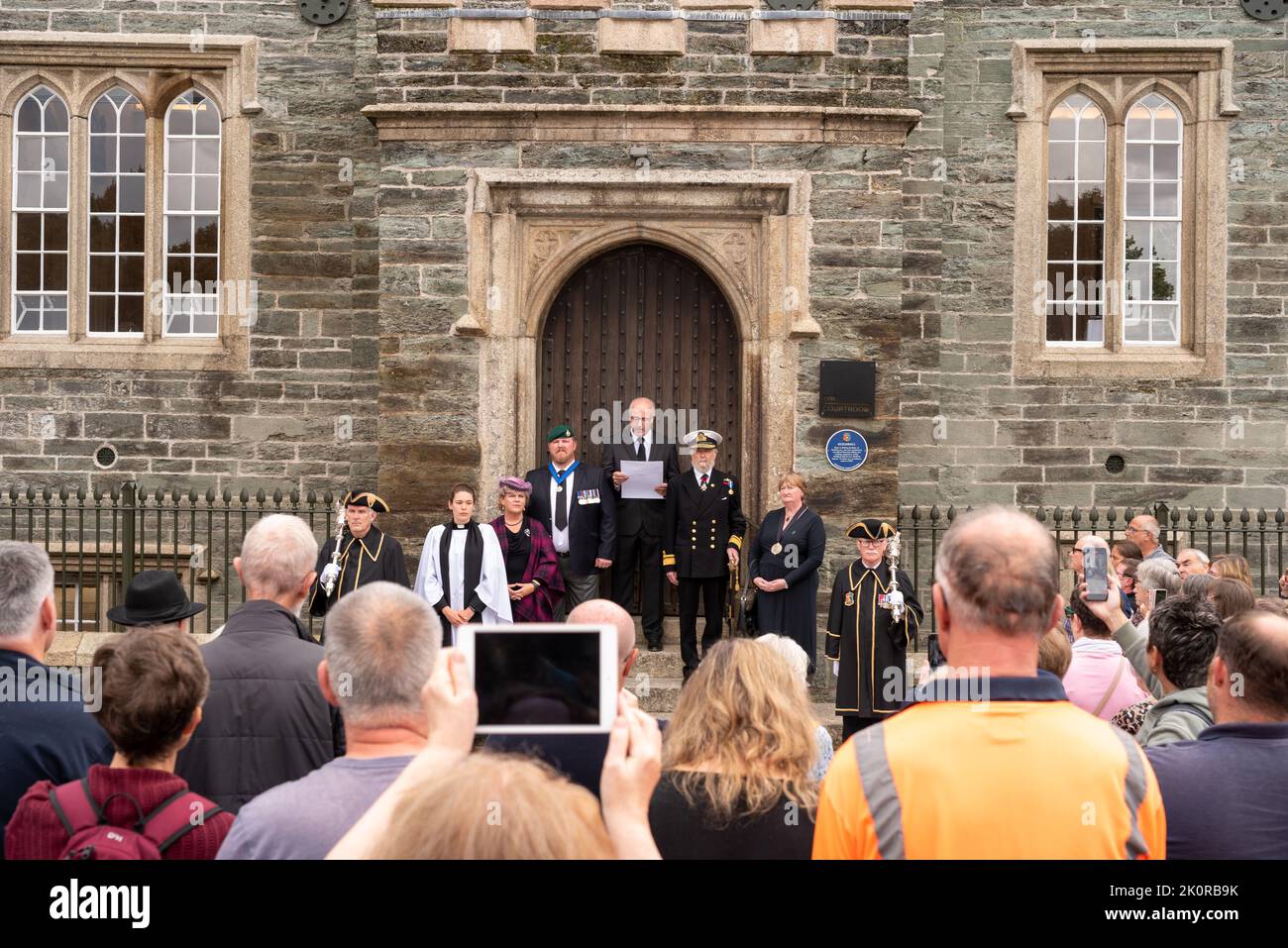 The Clerk to Tavistock Town Council, Carl Hearn, read the Proclamation from the steps of The Guildhall joined by dignitaries and Civic leaders including Ric Cheadle (Deputy Lord Lieutenant of Devon), Councillor James Ellis (Deputy Mayor of Tavistock), Councillor Caroline Mott (Mayor of West Devon), County Councillor Debo Sellis, Reverend Rosie Illingworth, and accompanied by the Town’s Mace Bearers Stock Photo