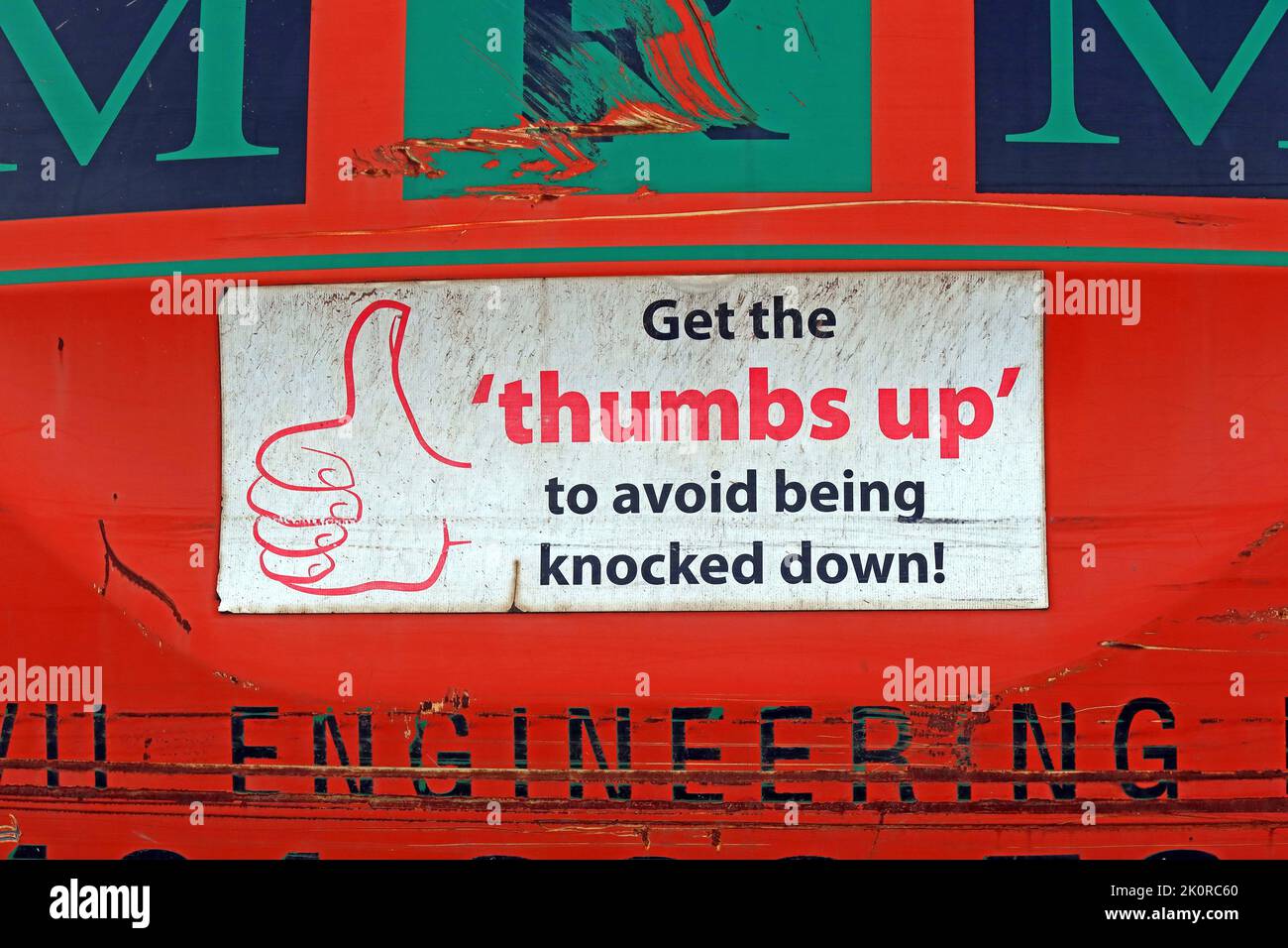 Warning sign on construction vehicle, Get The thumbs up, to avoid being knocked down - Health and Safety notice Stock Photo
