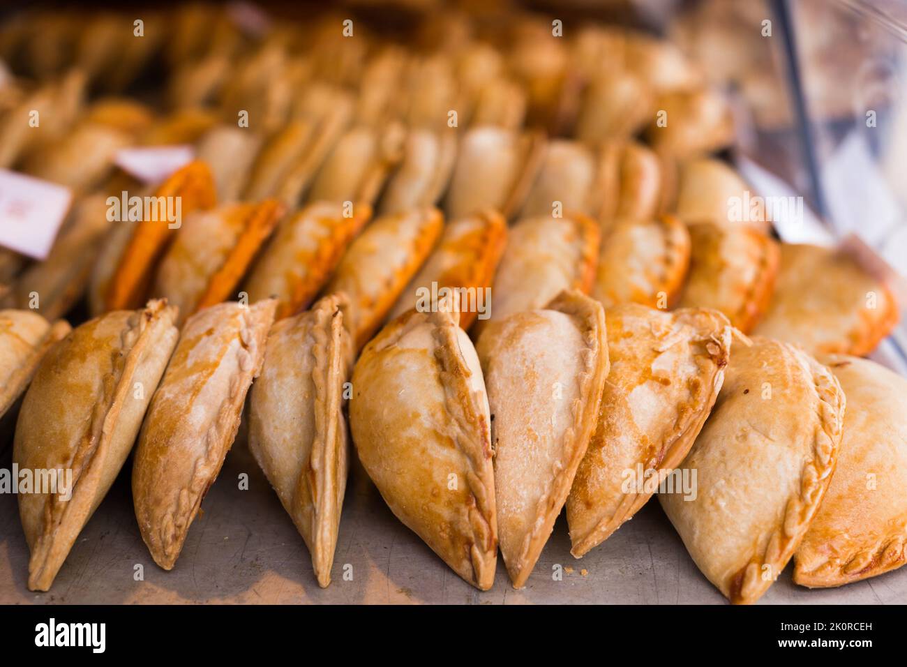freshly baked empanadas with different fillings for sale Stock Photo
