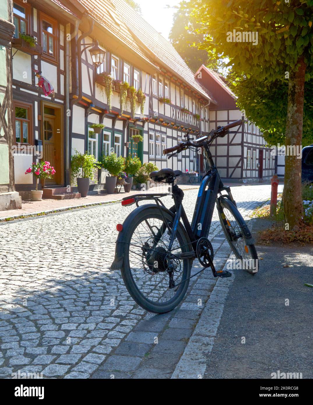 NCM bike parked in front of historic half-timbered houses in an alley during a bike tour through the Harz mountains in Stolberg, Germany, September 4, Stock Photo