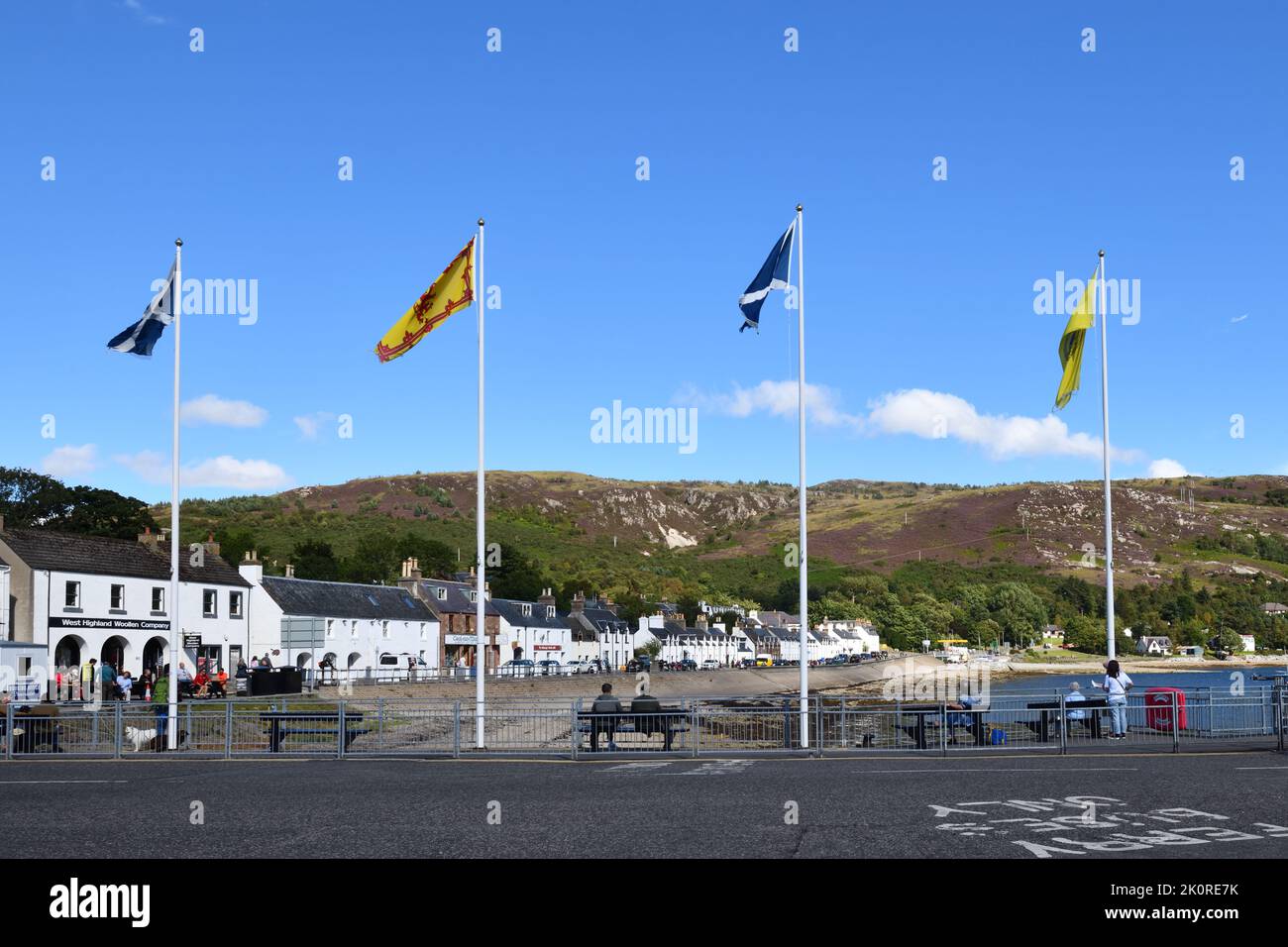 A row of white houses and shops on the shoreline front street at Ullapool, Scotland, UK Stock Photo