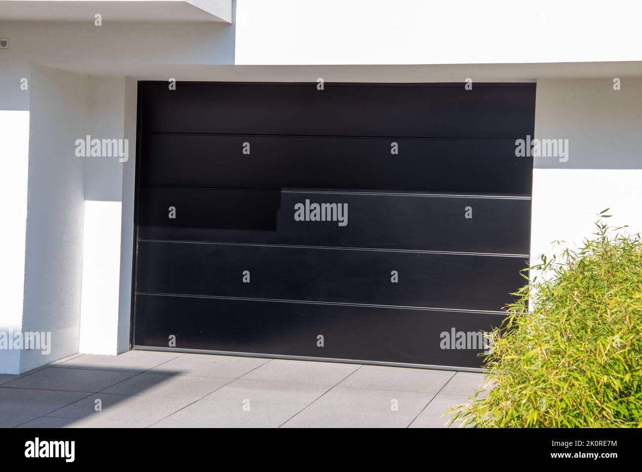 New black garage door (sectional door) on a residential house Stock Photo