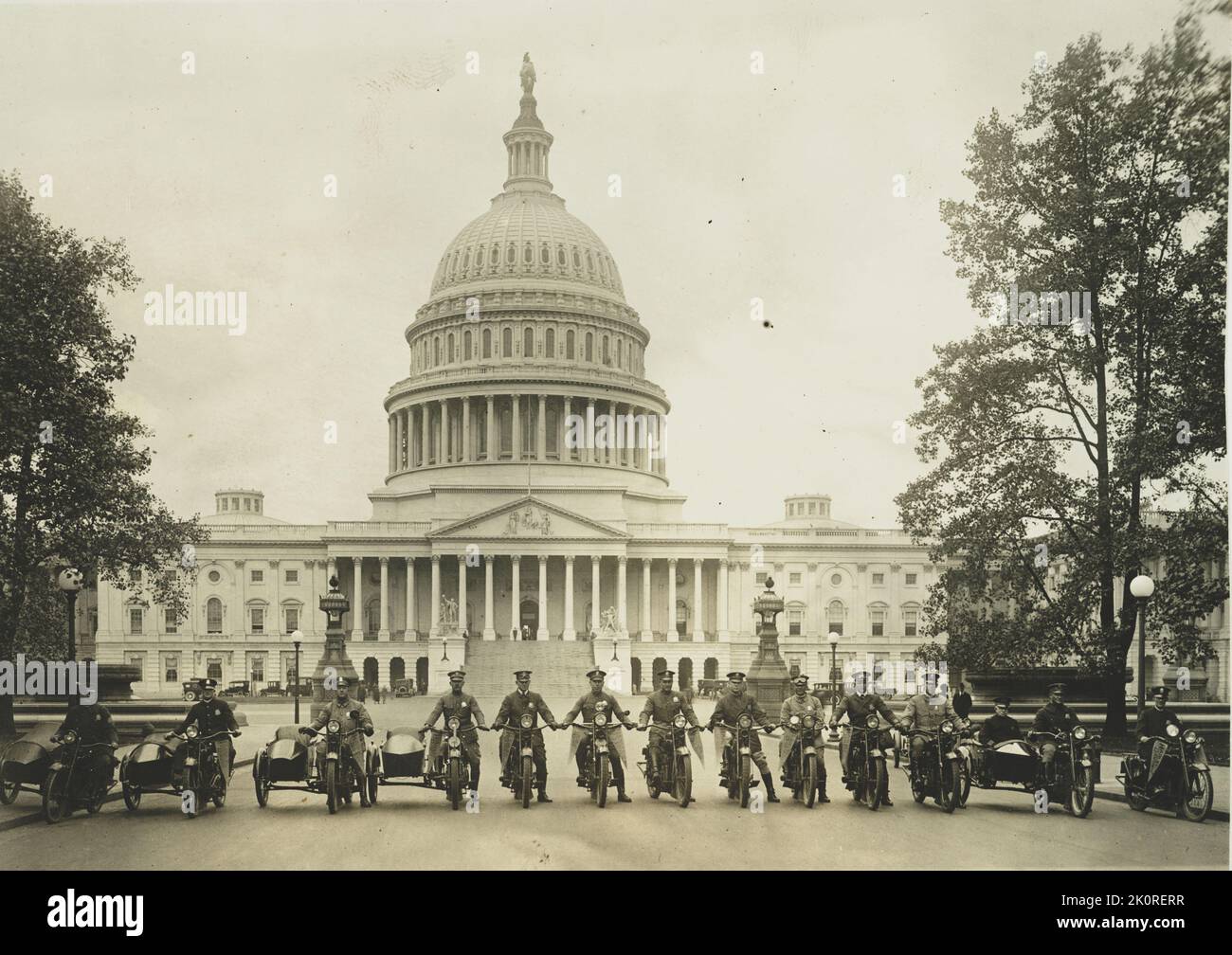 Photograph of a group of 'Washington's Finest' motorcycle policemen posed with a view of the Capitol in the background, Washington, DC, 4/26/1922. (Photo by National Photo Company) Stock Photo