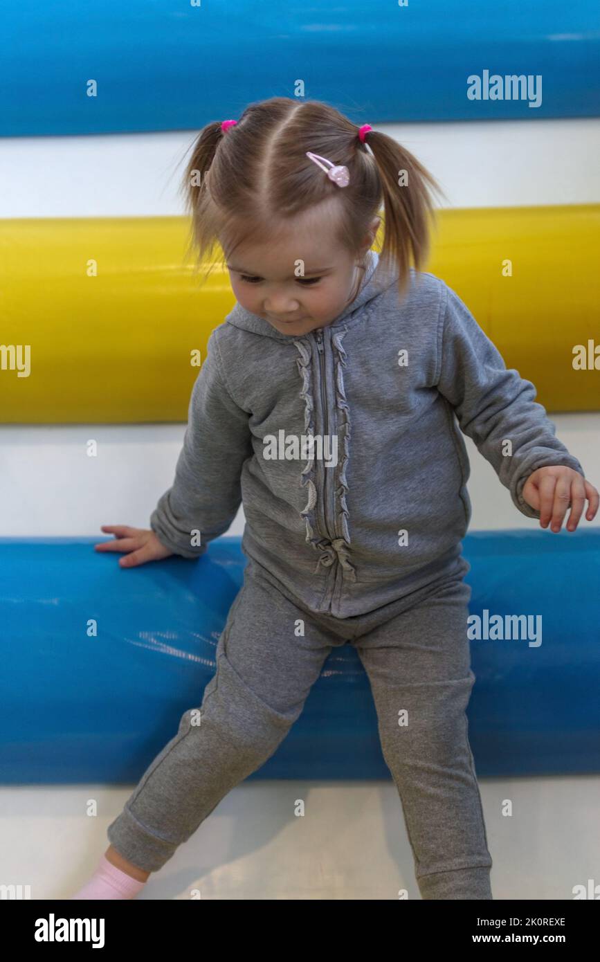 Child girl climbing down ramp in soft play centre Stock Photo - Alamy