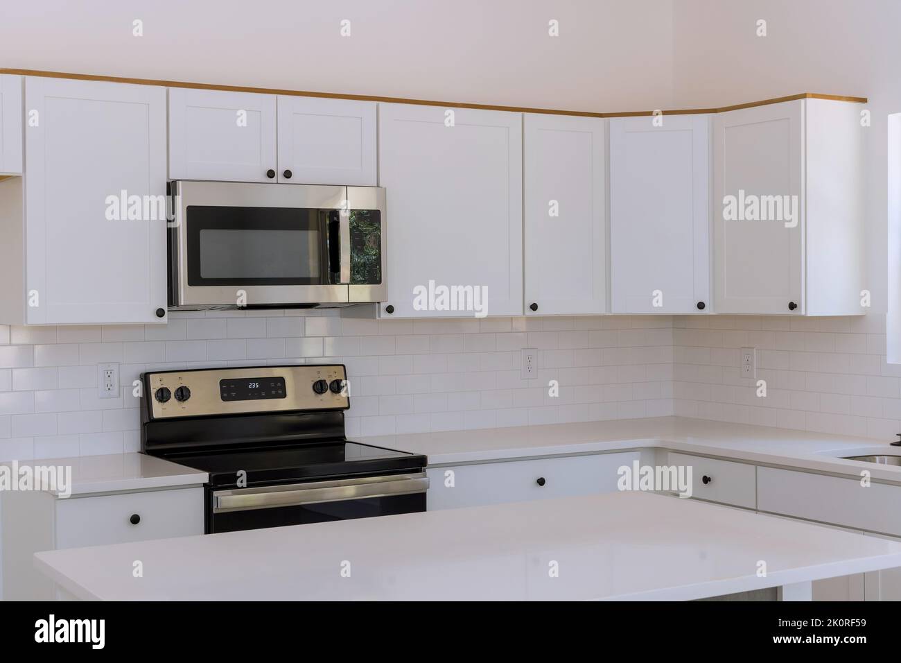 New kitchen appliances and kitchen cabinets are being installed in a newly constructed house Stock Photo