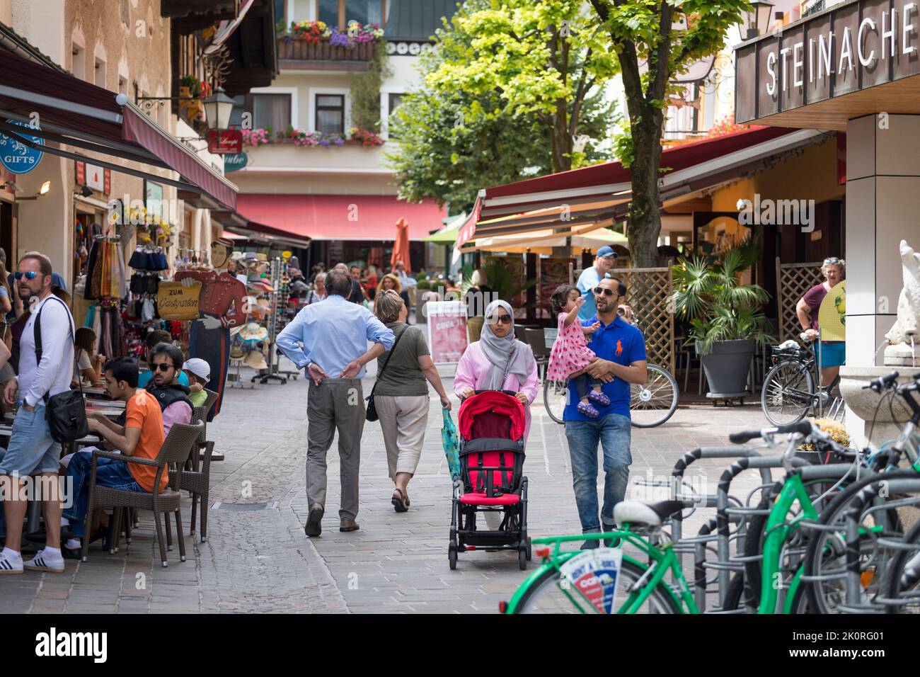 Arab couple with child walking busy shopping street in Zell am See, Austria Stock Photo