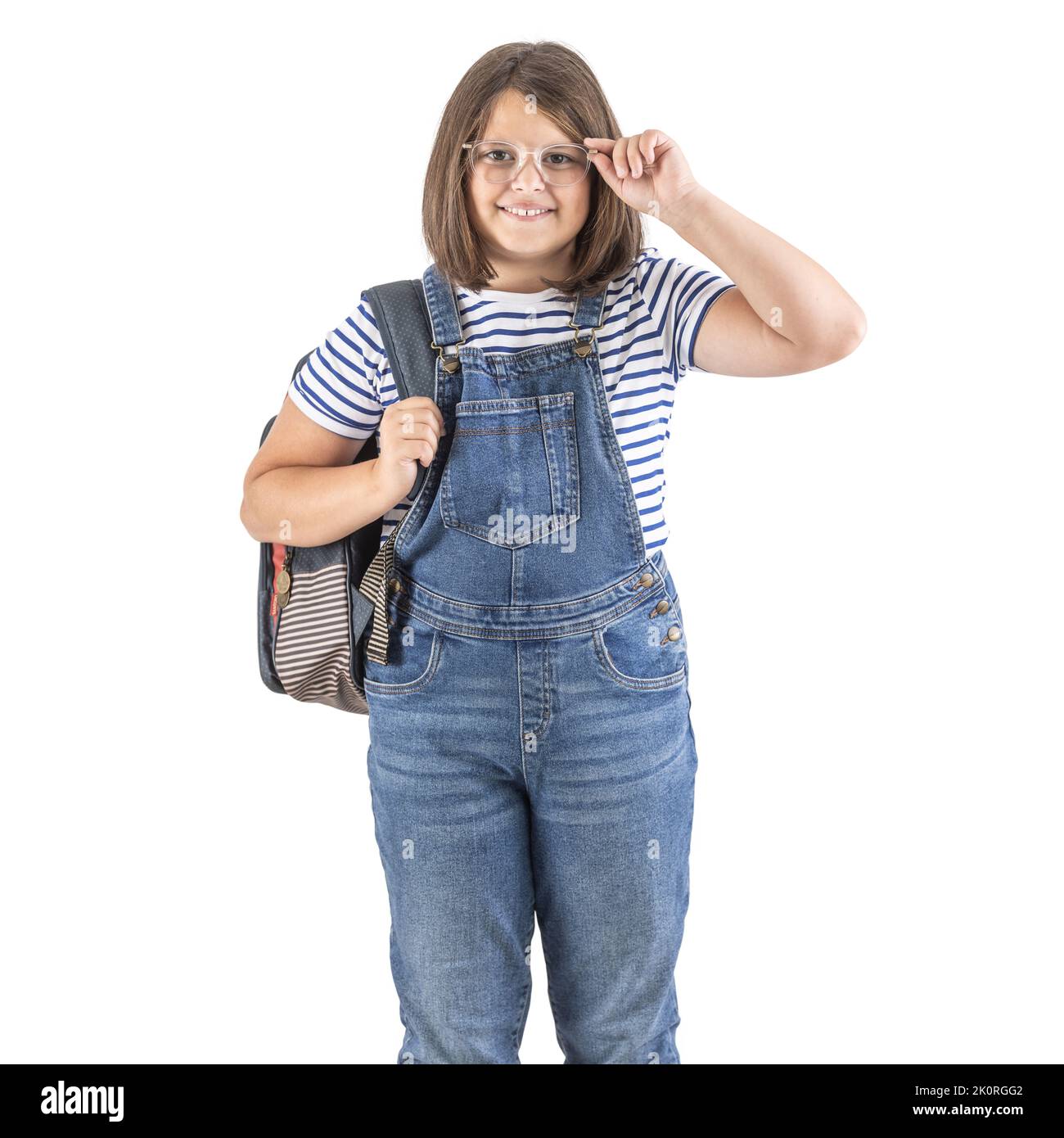 Happy girl in glasses wears backpack and casual school outfit. Stock Photo