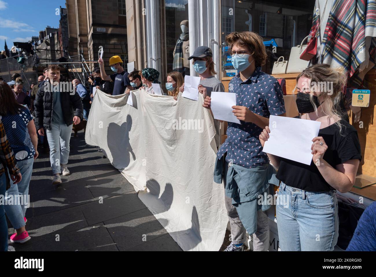 Edinburgh, Scotland, UK. 13th September 2022. ** Corrected to show correct location ** Demonstration on Royal Mile today with activists holding up white paper sheets.The activists held up blank placards and banners in solidarity with people arrested for protesting the Monarchy in recent days. Iain Masterton/Alamy Live News Stock Photo
