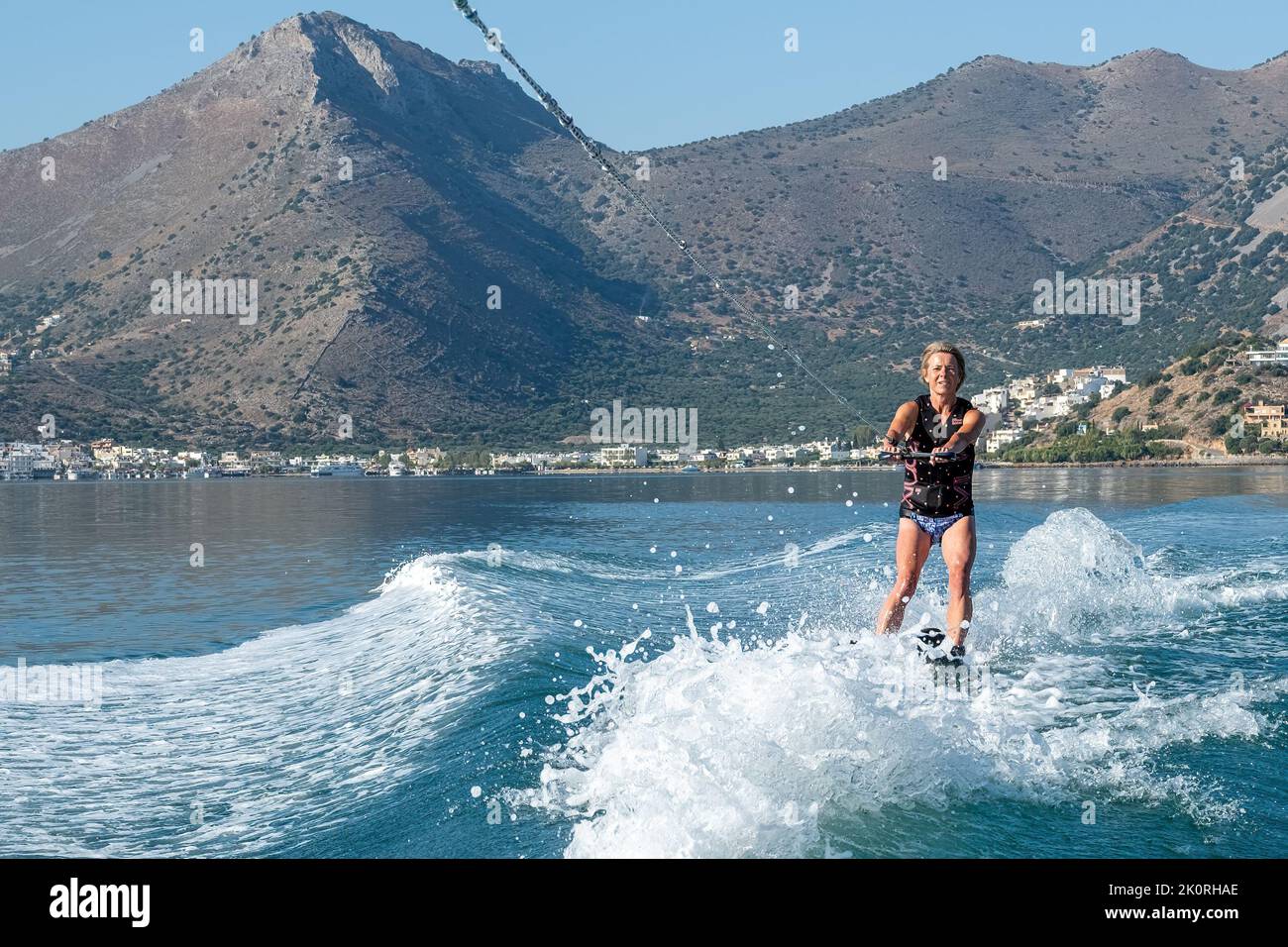Holiday water skiing in Elounda Bay, Crete. A naturally sheltered scenic bay that provides an ideal waterskiing location. Stock Photo