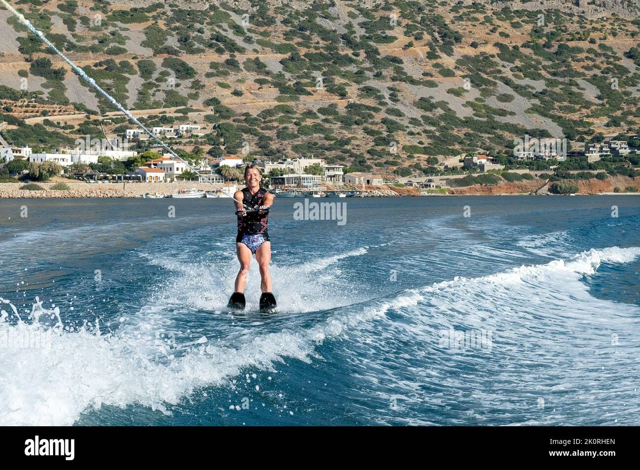 Holiday water skiing in Elounda Bay, Crete. A naturally sheltered scenic bay that provides an ideal waterskiing location. Stock Photo