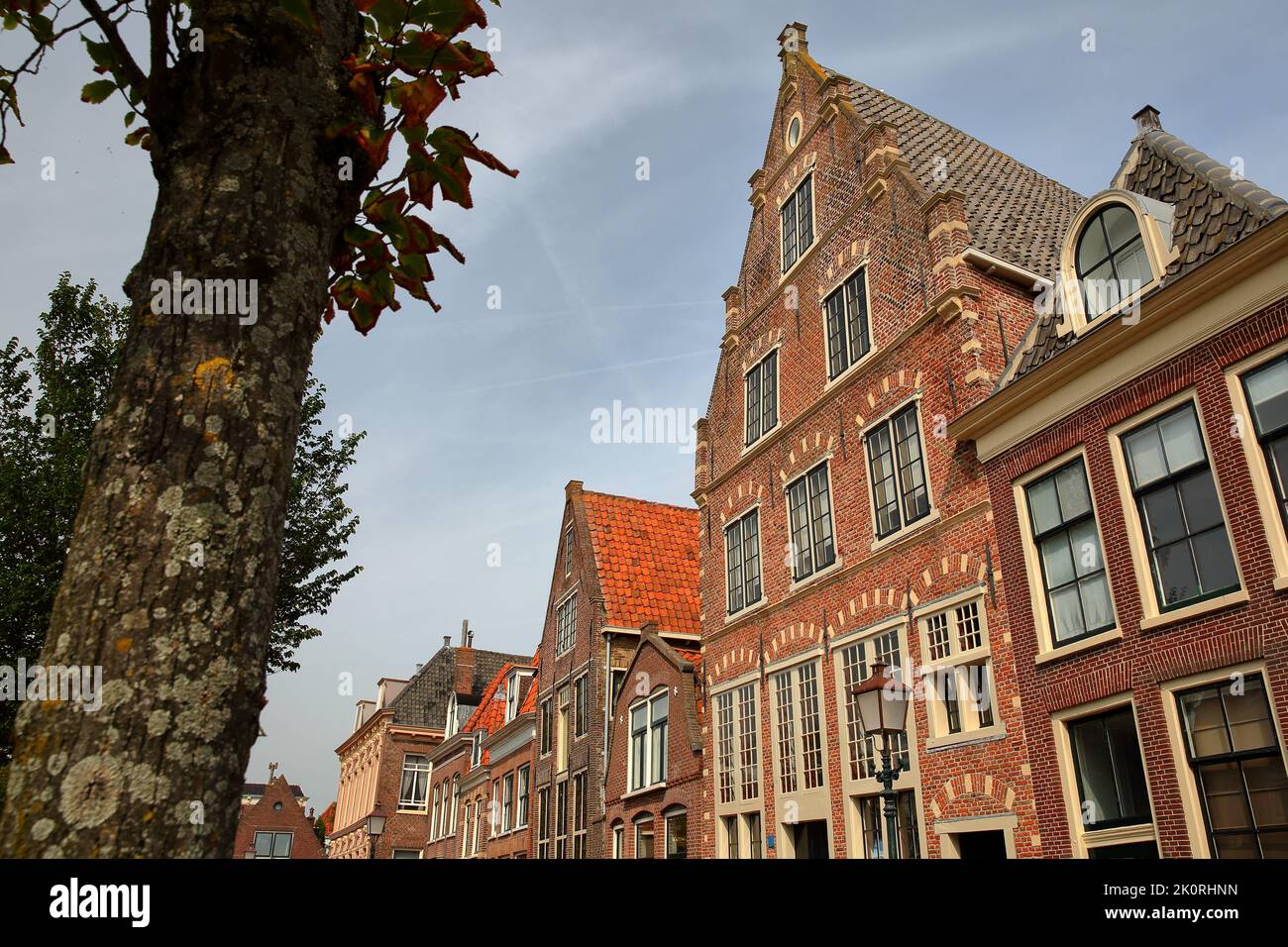 The colorful facades of historic houses located along Korenmarkt street near the harbor (Binnenhaven) of Hoorn, West Friesland, Netherlands Stock Photo