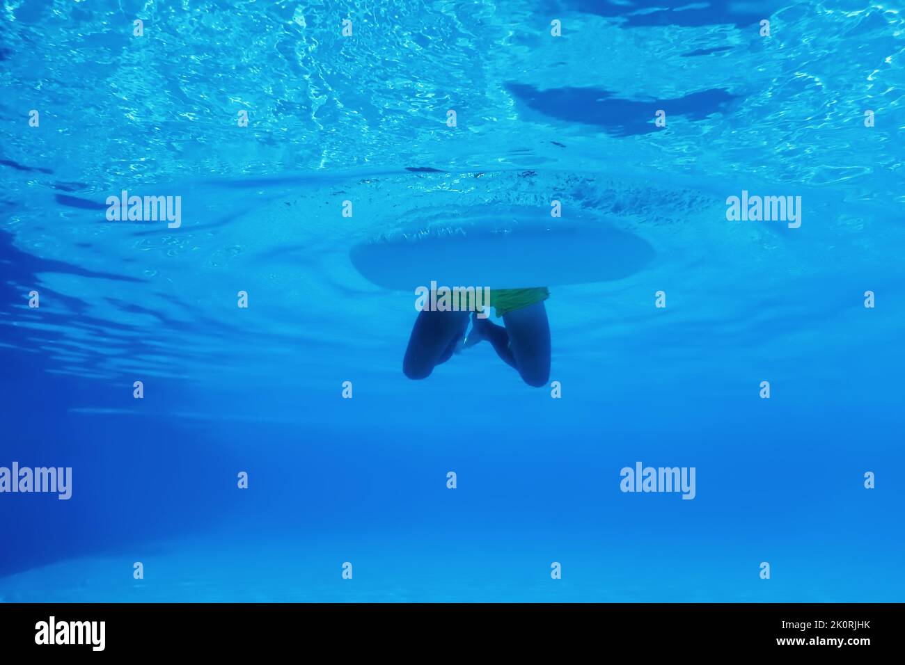 Underwater photo of boy with float swimming in pool Stock Photo - Alamy