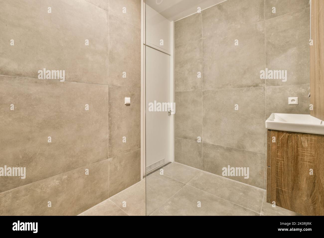Glass partition between shower tap a in modern restroom at home Stock