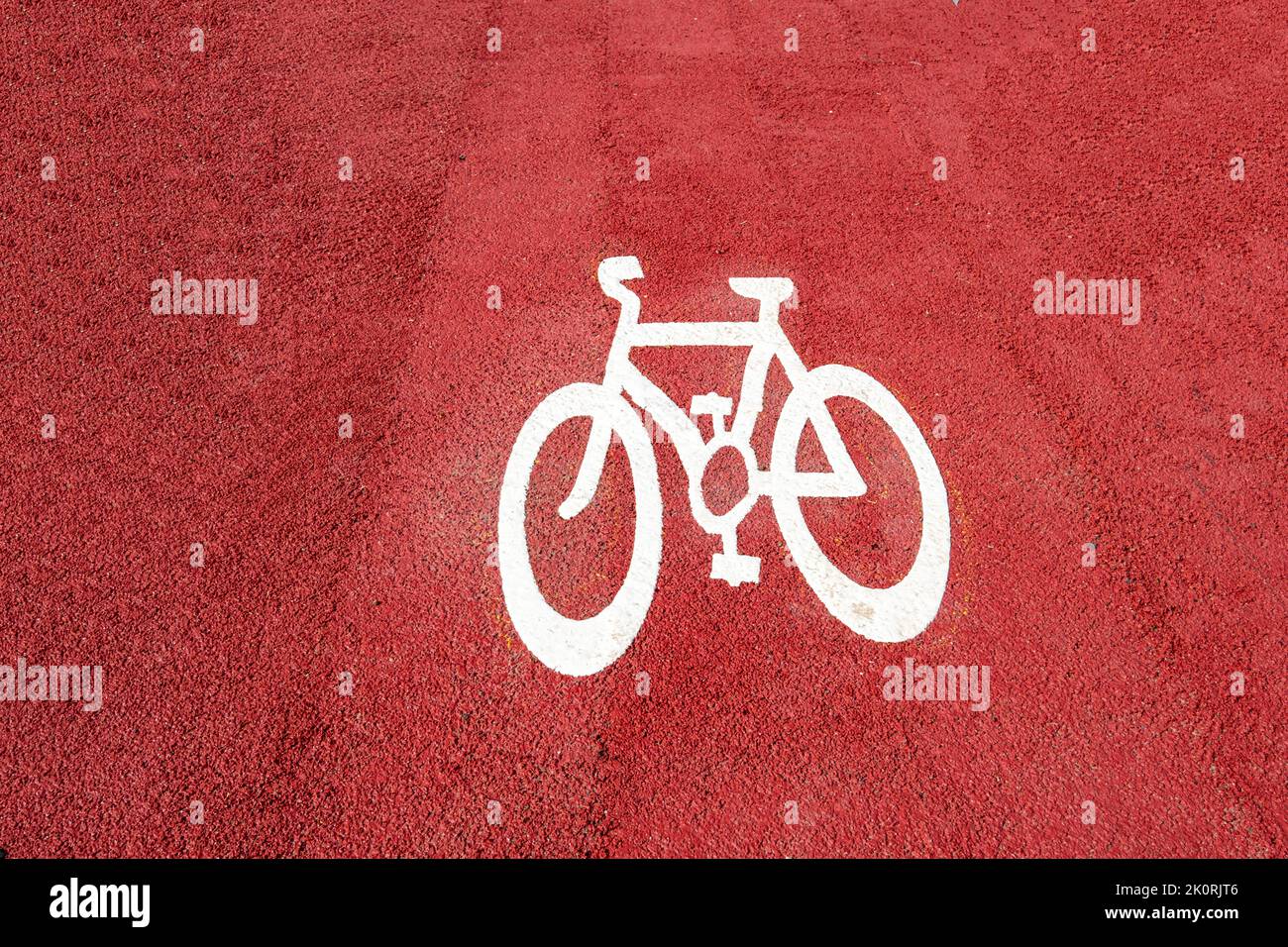 Bicycle symbol painted on red tarmac UK Stock Photo