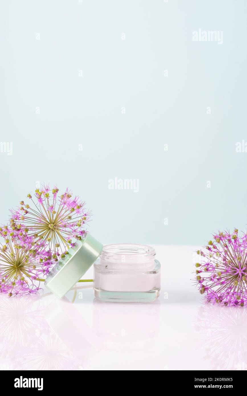 cosmetic cream with flowers on a white background. Face and hand skin care. Natural cosmetic. Stock Photo