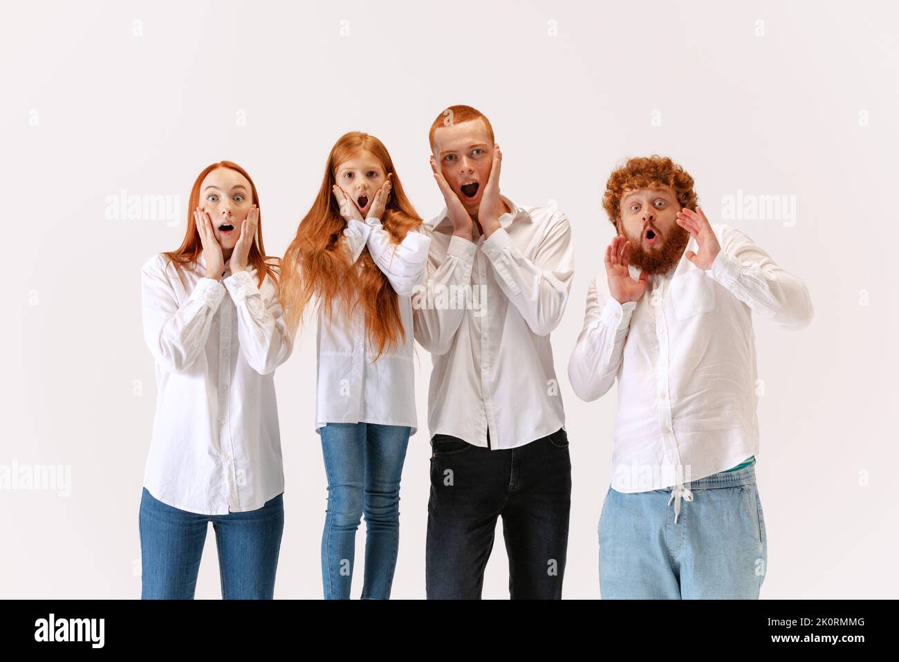 Surprised family, redheaded young men, woman and kid wearing casual ...