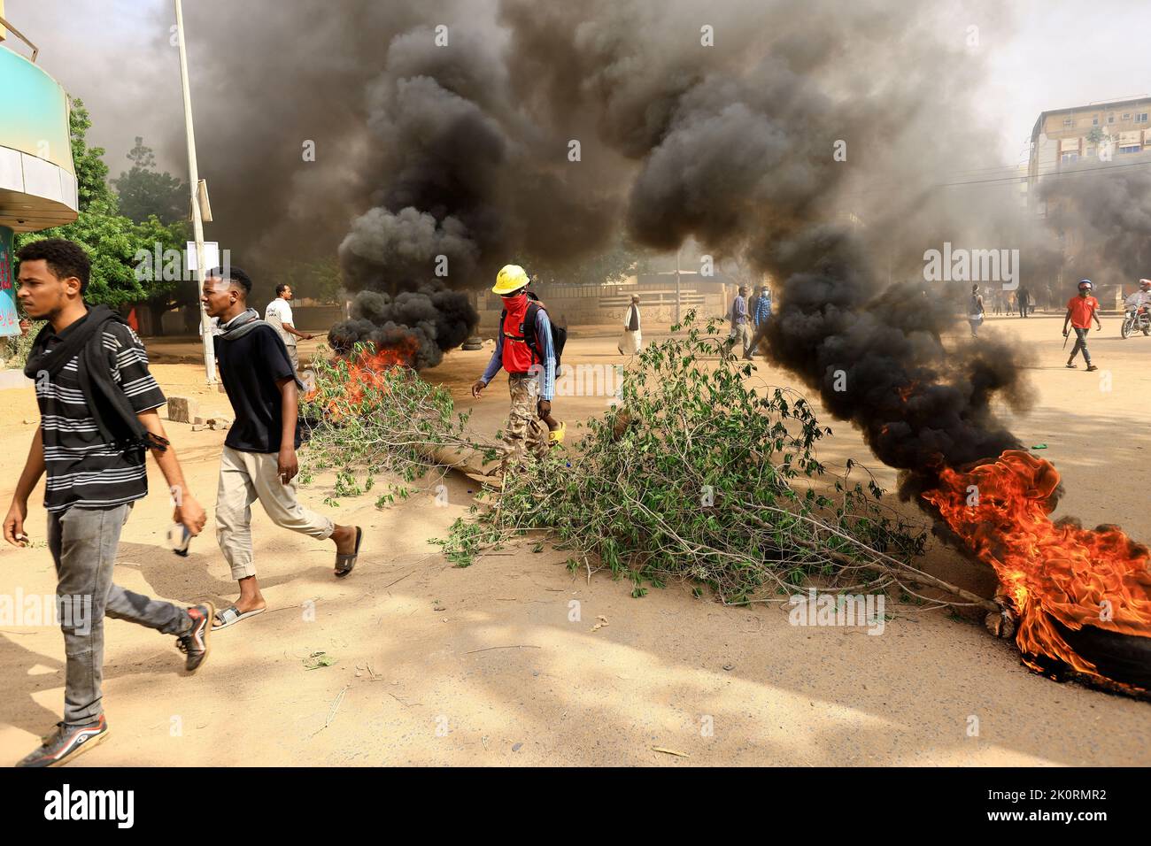 Protesters march past burning barricades during a rally against the military rule following the last coup, in Khartoum, Sudan September 13, 2022. REUTERS/Mohamed Nureldin Abdallah Stock Photo