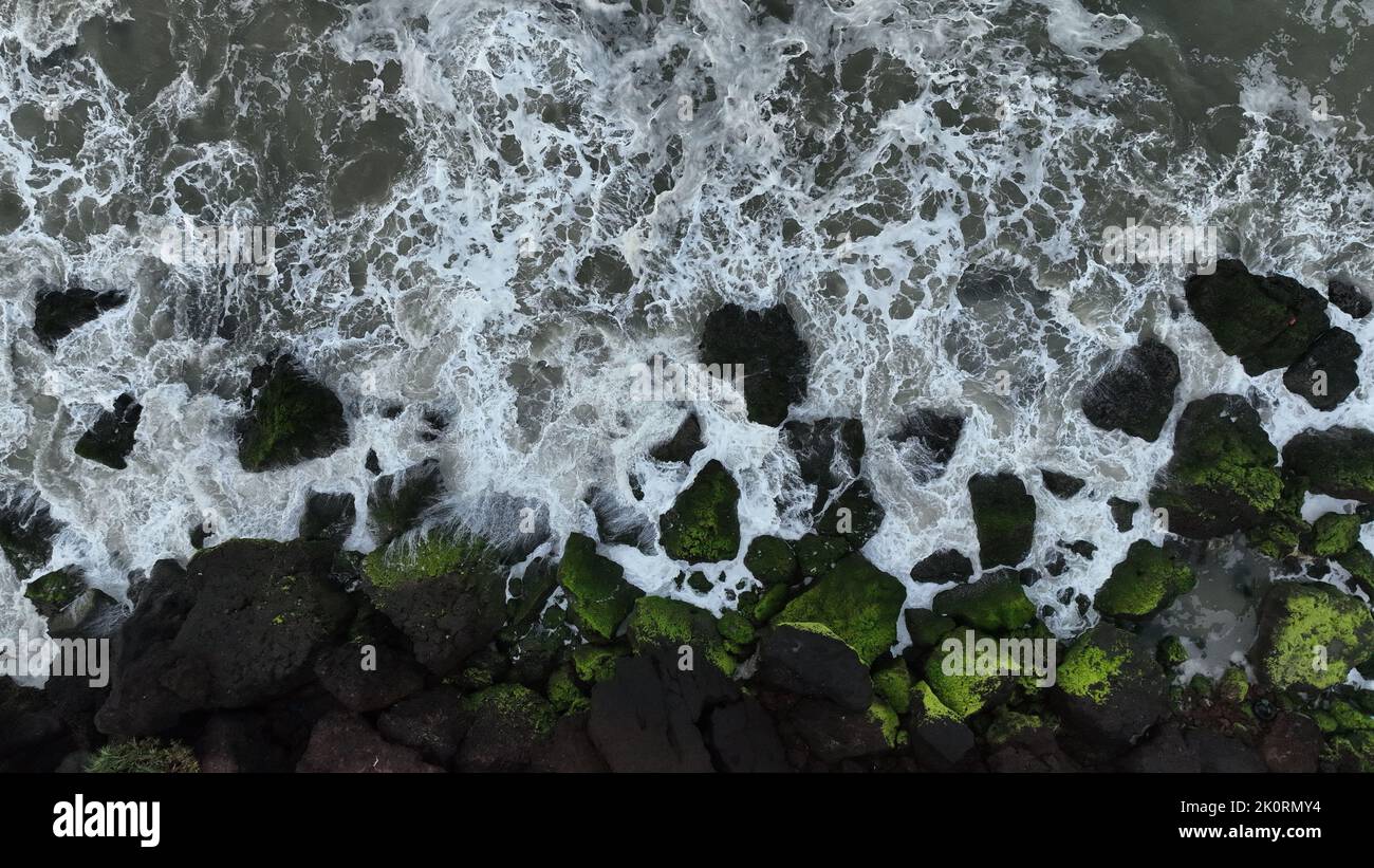 An aerial view of a rocky coast with sea waves splashing Stock Photo ...