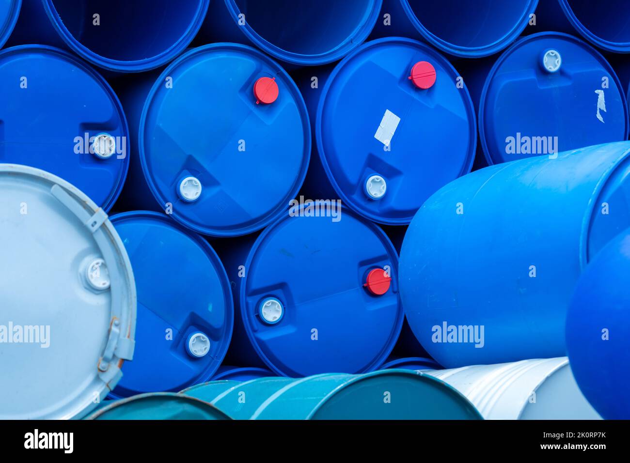 Old chemical barrels. Empty blue chemical drums stack. Steel and