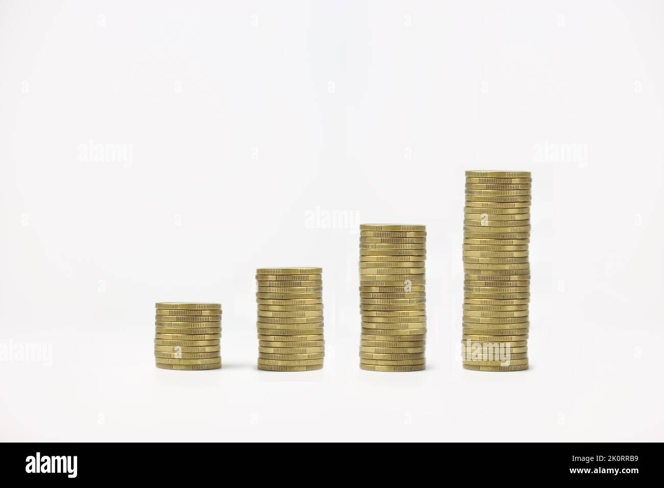 Stacked coins on a white isolated background. Investment growth concept ...