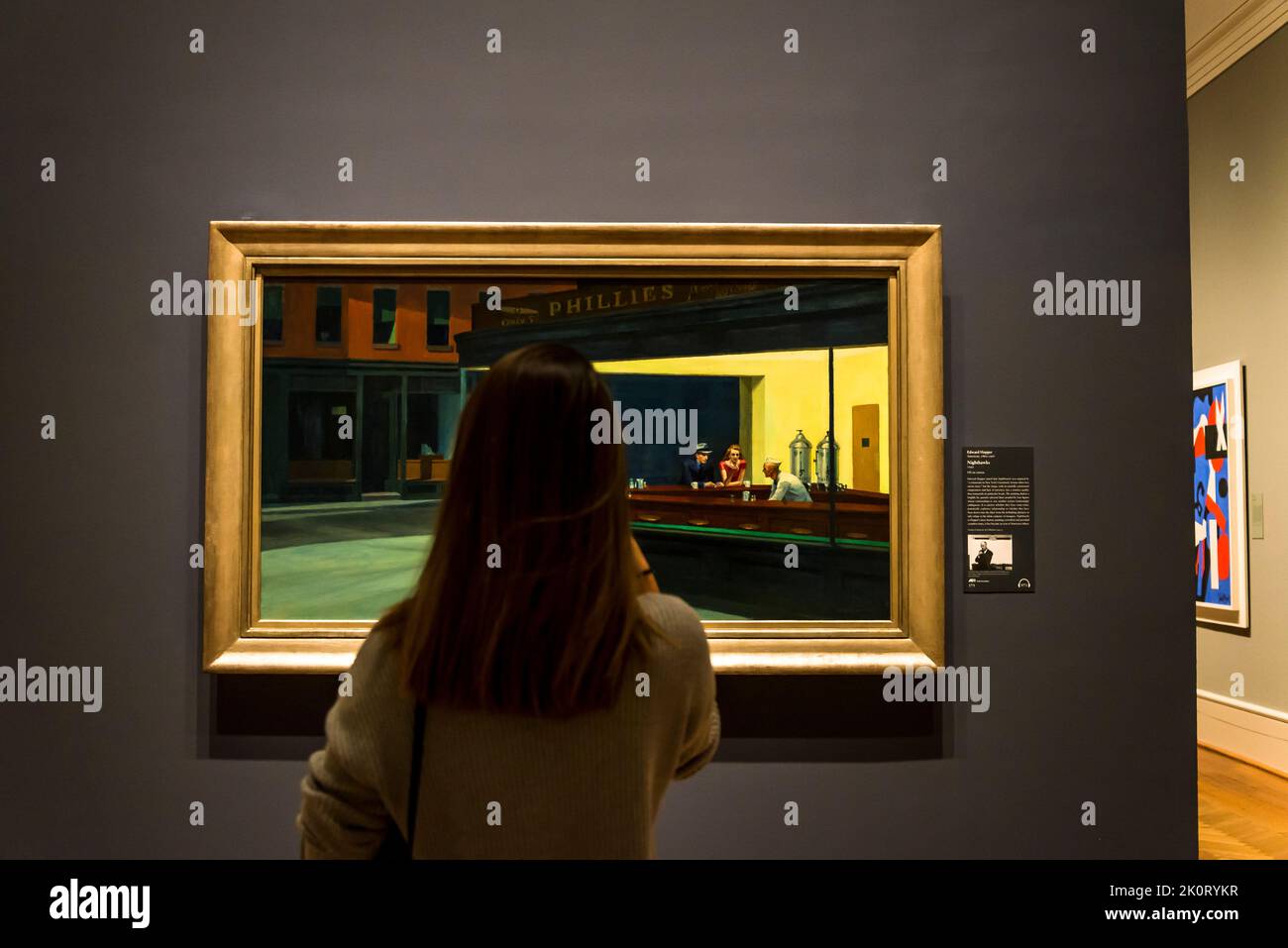 Visitor looking at Edward Hopper painting Nighthawks, The Art Institute of Chicago, Chicago, Illinois, USA Stock Photo
