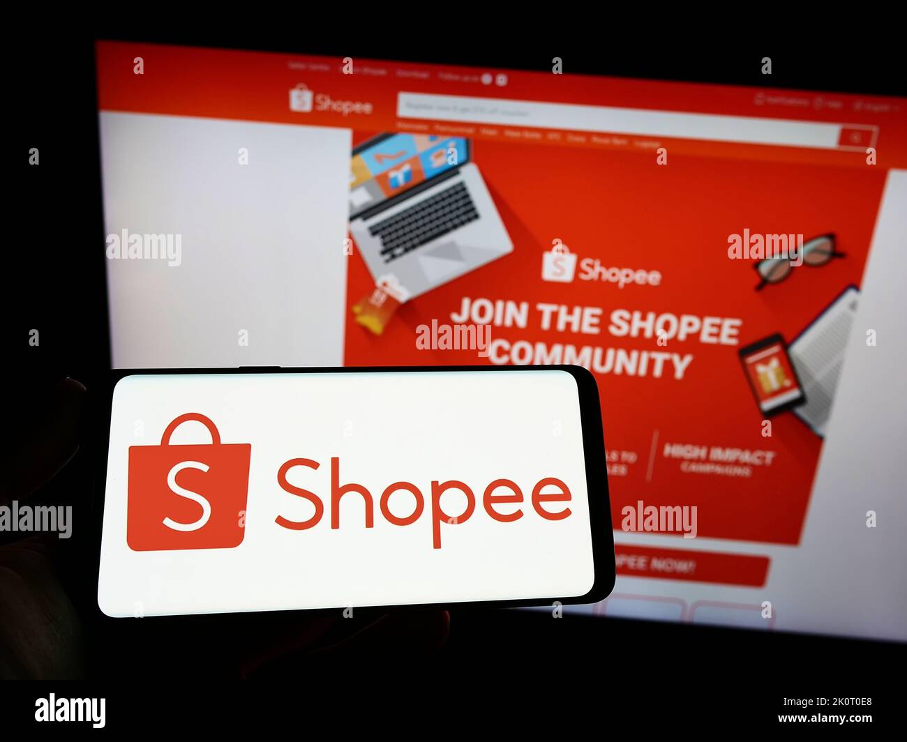 Shopee is e-commerce technology company. Smartphone with Shopee logo on the  screen, shopping cart and parcels Stock Photo - Alamy