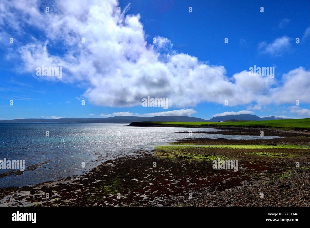 The Orkney coastline at Orphir looking towards Houton and the hills of Hoy. Stock Photo