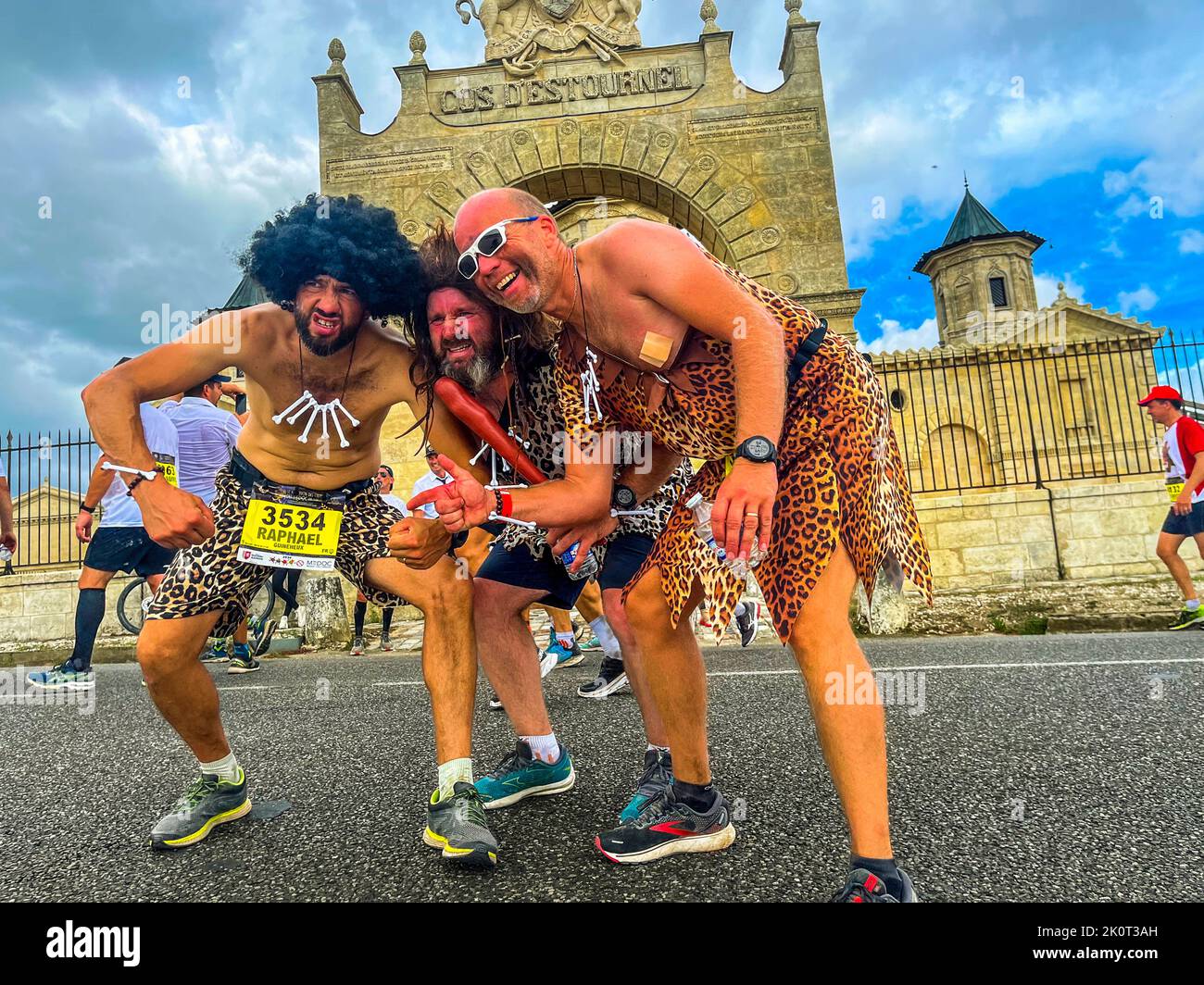 The organizers of the Marathon des Chateaux du Medoc like to talk about the longest or even toughest race in the world. Despite the many climbs on the course and the high temperature, many runners mobilize the last energy for a posing in front of the camera Stock Photo