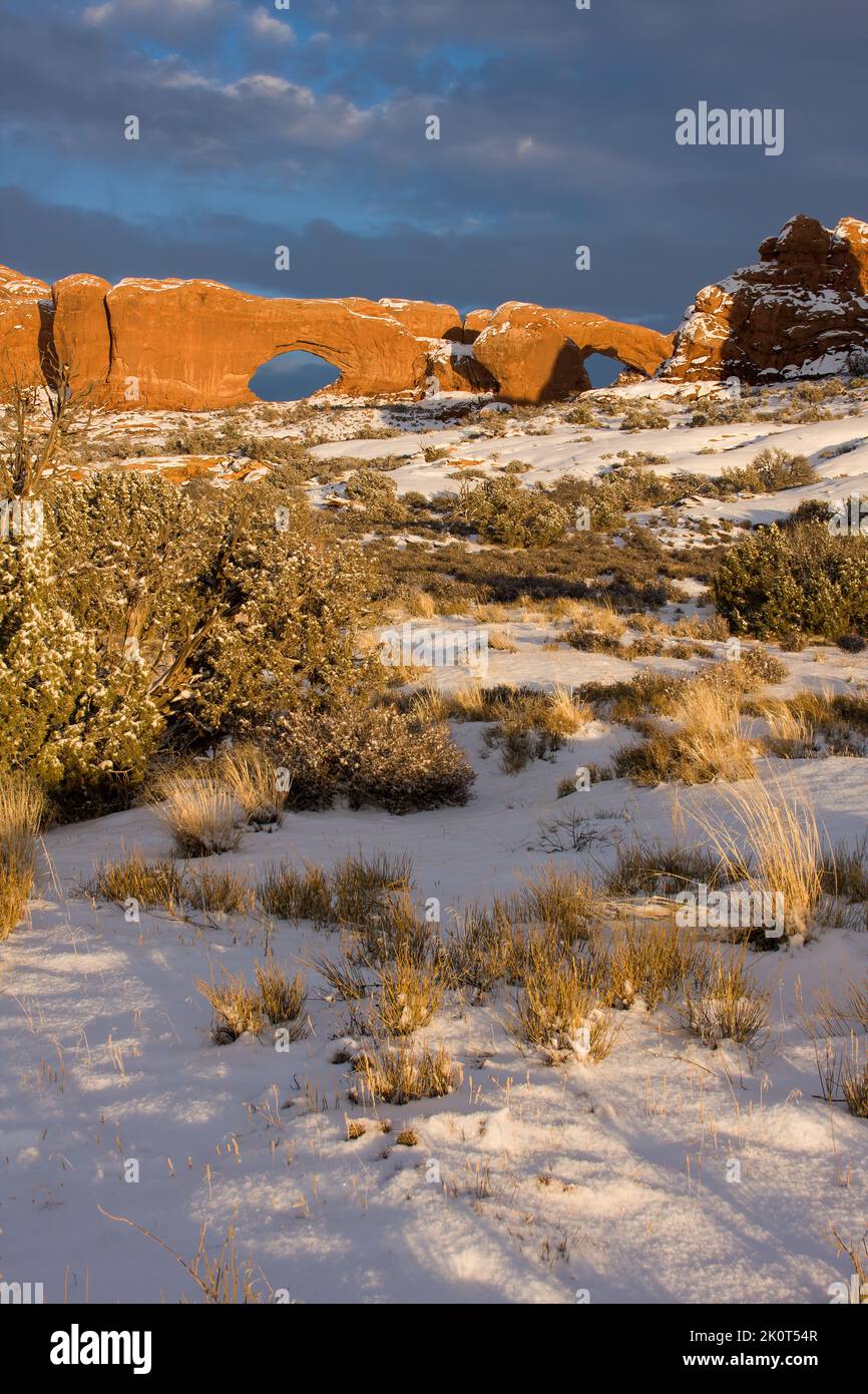 The North Window and South Window with snow in the Windows Section of Arches National Park in winter.  Moab, Utah. Stock Photo