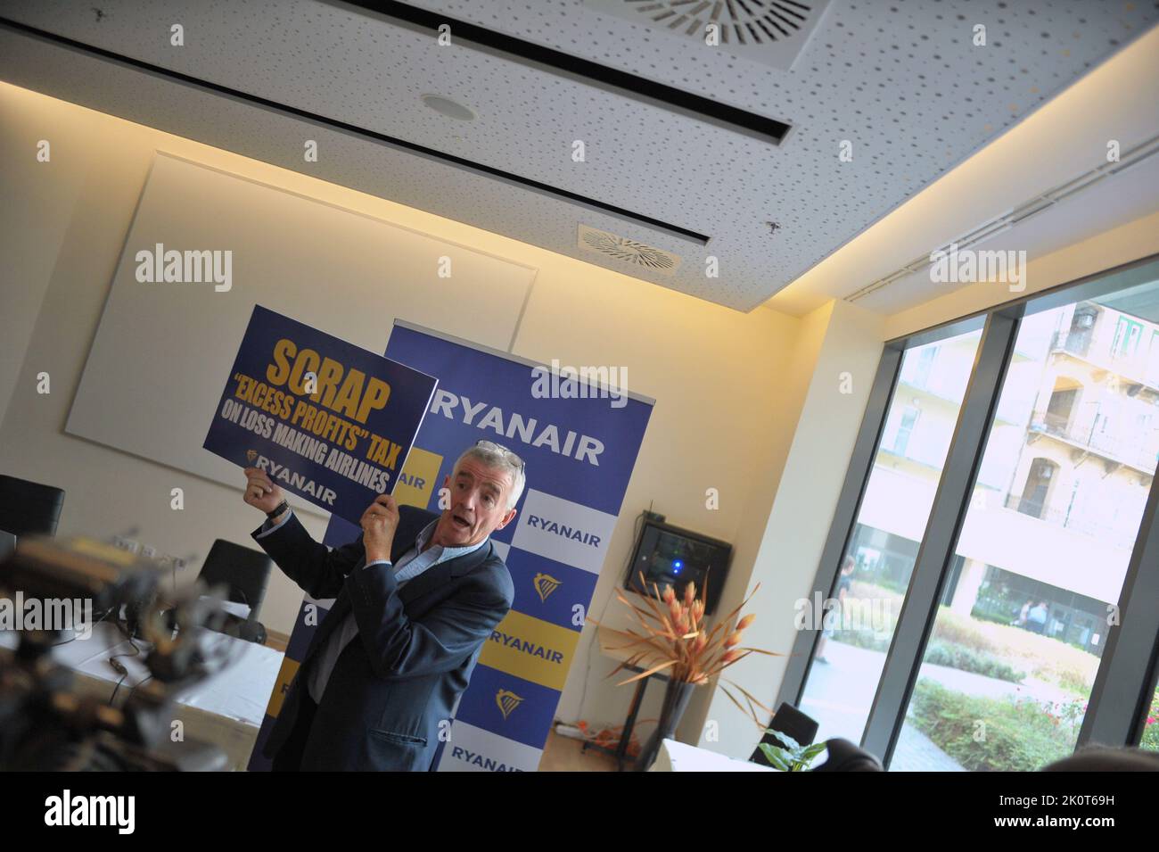 The CEO of Ryanair, Michael O’Leary holds a sign saying 'Scrap 'Excess Profits' Tax on loss making airlines', Budapest, Hungary, 13th Sep 2022, Balint Szentgallay / Alamy Live News Stock Photo