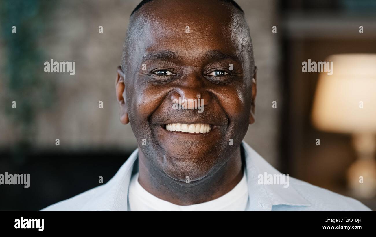 Glad happy african american grandfather ethnic man unshaved elderly 60s retired confident businessman handsome mature gentlemen laughing smiling white Stock Photo