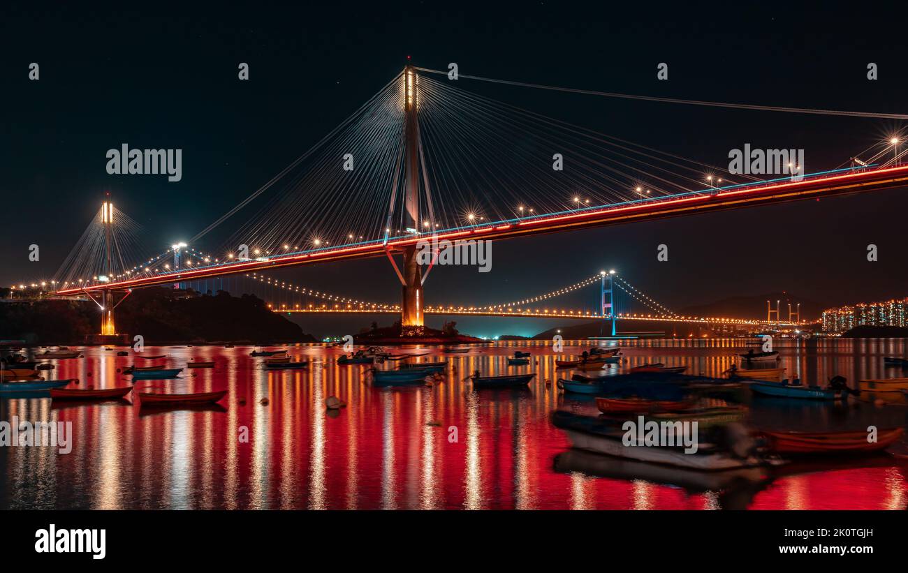 An illuminated suspension bridge at night Stock Photo - Alamy