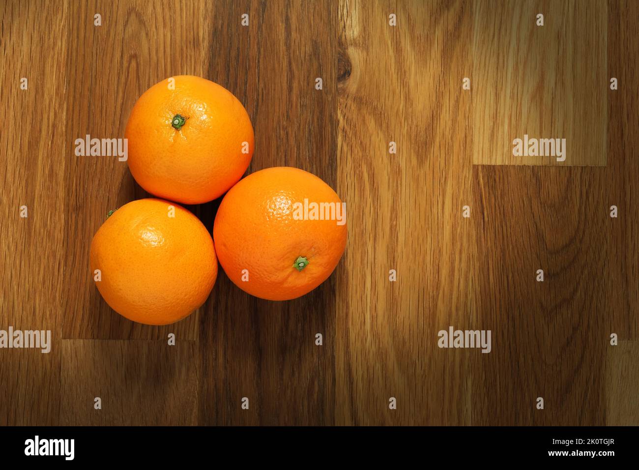 Fresh oranges shot from above on a wooden table surface Stock Photo